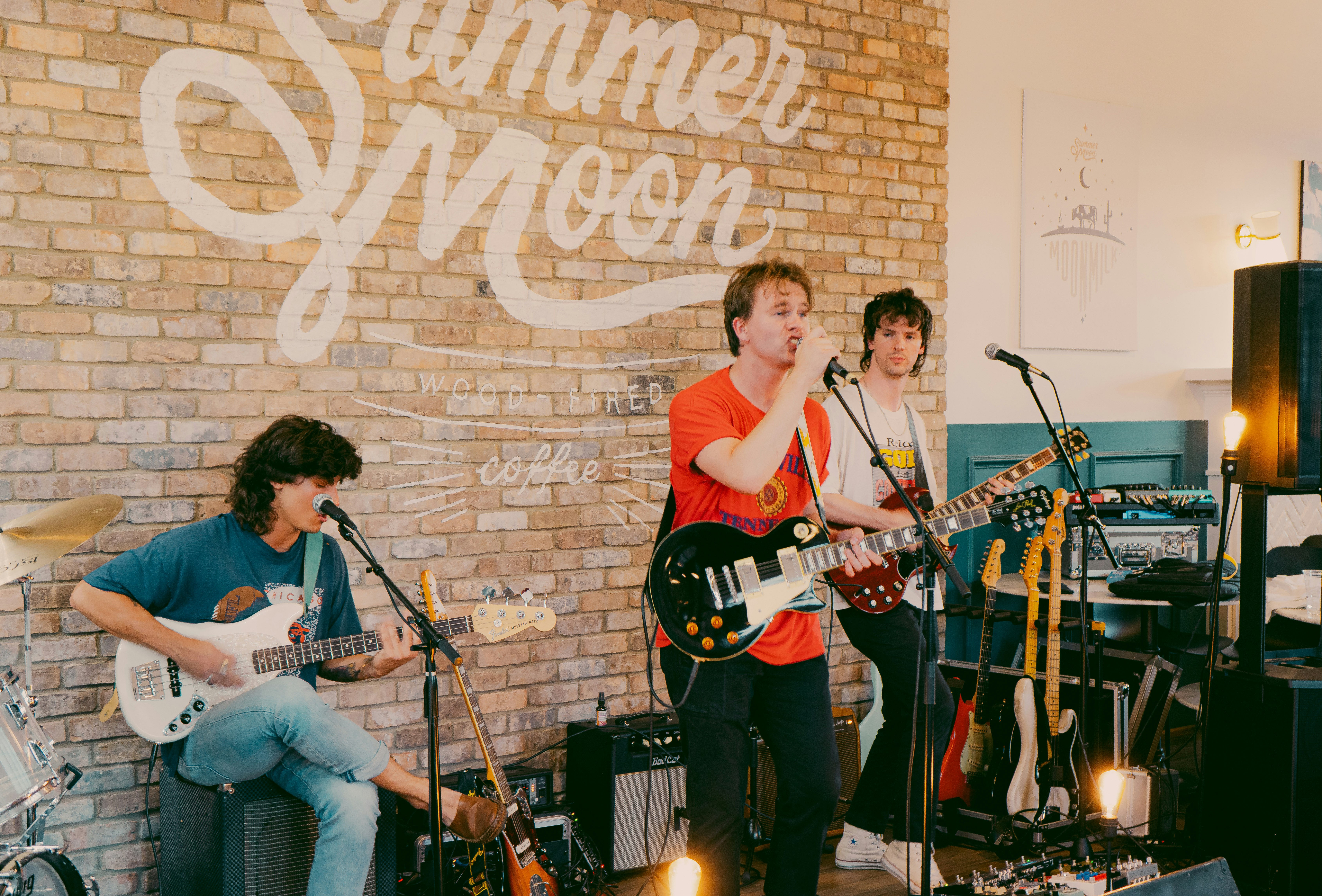 man playing electric guitar beside woman playing guitar